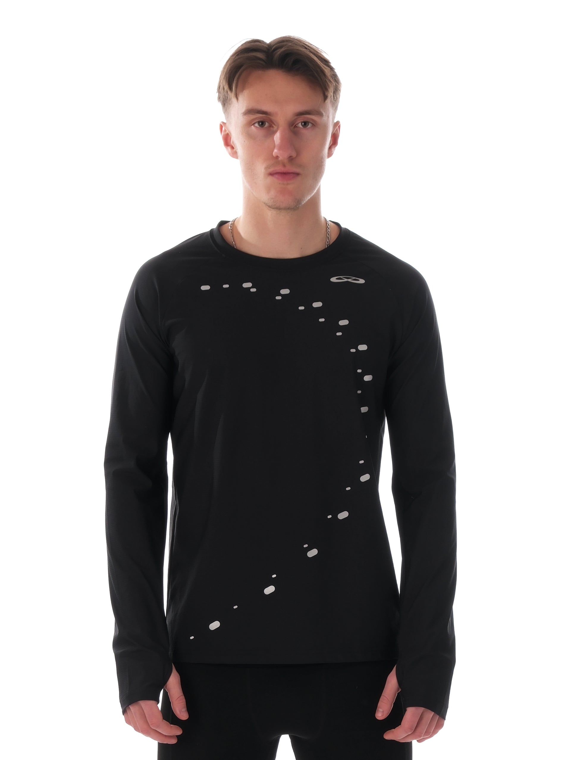 Man wearing a black long-sleeve shirt with white patterns on a white background